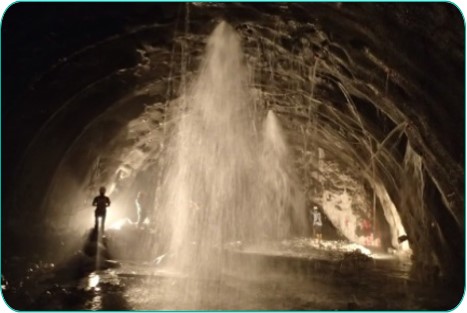 Figure shows water gushing during tunnel excavation.